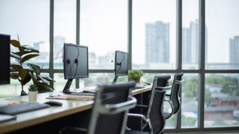 Display Screen Equipment online course: office desks with computer screens by large windows